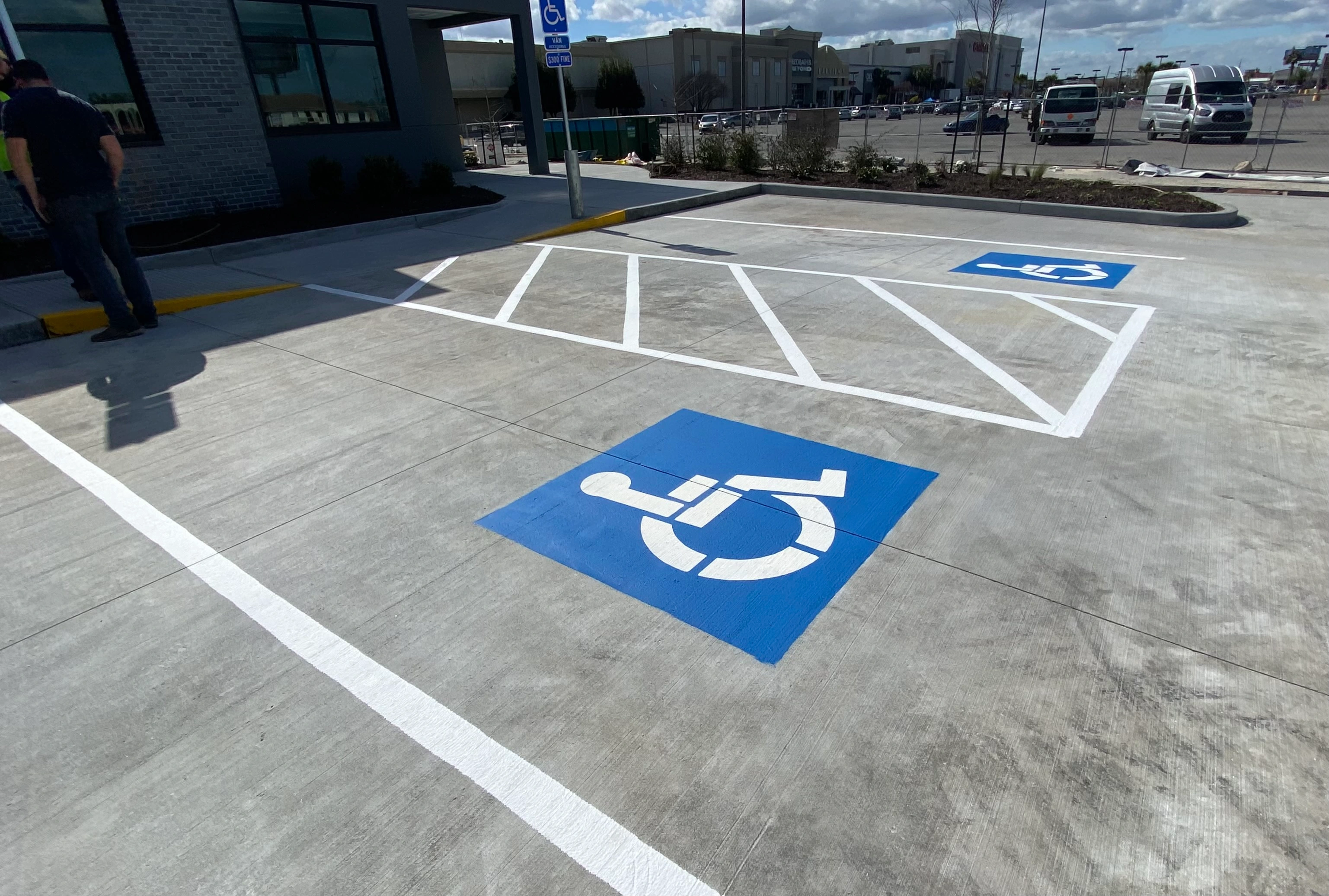 ADA compliant parking markings New Orleans — blue handicap symbols and access aisle