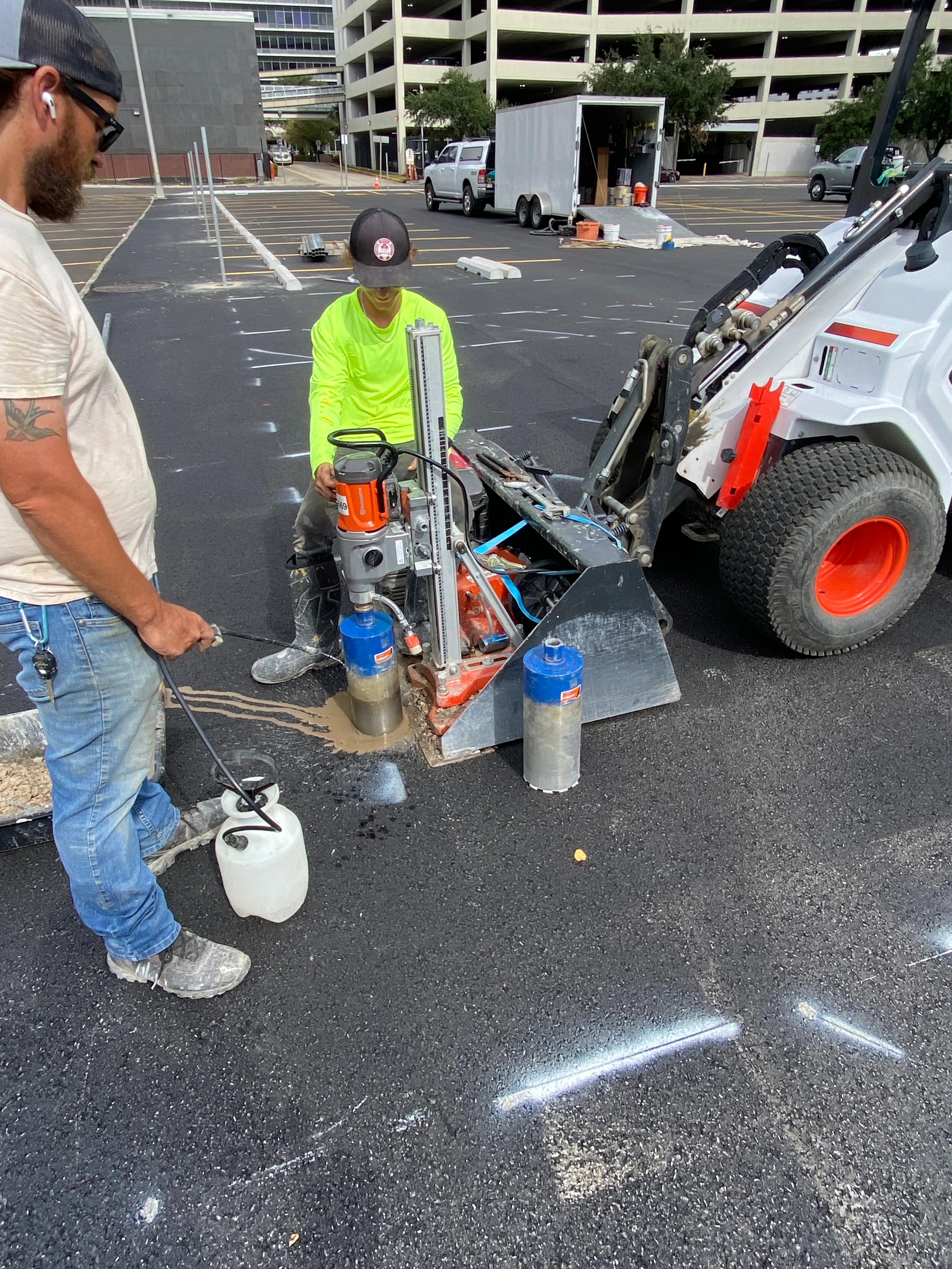 Parking sign installation New Orleans — core drilling for sign post in commercial parking lot